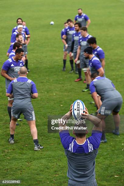 Dane Coles of the New Zealand All Blacks throws the ball into the lineout during training at the Suresnes Rugby Club on November 22, 2016 in Paris,...