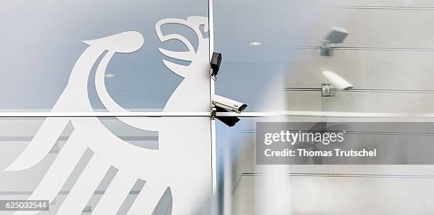 Berlin, Germany A surveillance camera hangs next to the coat of arms of the Federal Republic of Germany, an eagle, on a building on November 22, 2016...