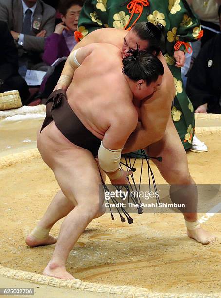 Ozeki Kisenosato pushes Mongolian yokozuna Hakuho out of the ring to win during day ten of the Grand Sumo Kyushu Tournament at Fukuoka Convention...