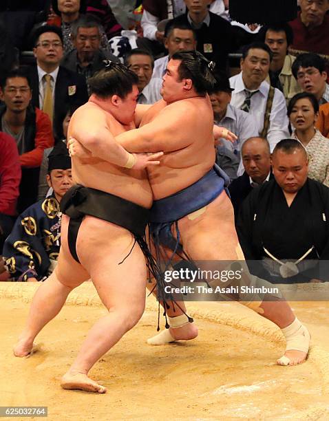 Ozeki Goeido pushes ozeki Kisenosato to win during day ten of the Grand Sumo Kyushu Tournament at Fukuoka Convention Center on November 22, 2016 in...