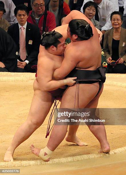 Endo pushes Nishikigi out of the ring to win during day ten of the Grand Sumo Kyushu Tournament at Fukuoka Convention Center on November 22, 2016 in...