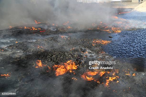 Smoke rises at oil wells, were set on fire by Daesh terrorists as they fled after Al Qayyarah town's cleansing from Daesh militants as the operation...