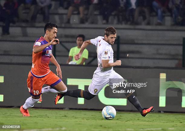 Northeast United FC's forward Emiliano Alfaro vies for the ball with FC Pune Citys defender Gouramangi Singh during the Indian Super League football...