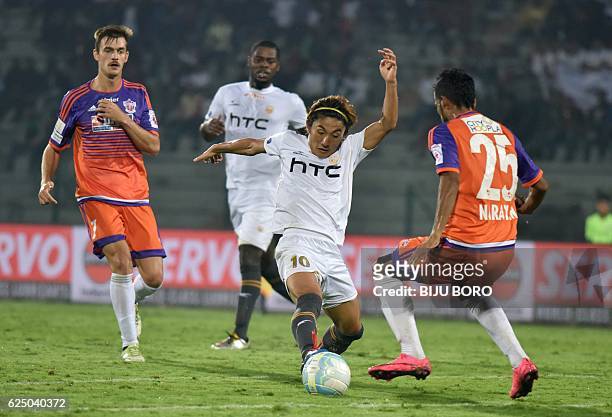 Northeast United FC's midfielder Katsumi Yusa vies for the ball with FC Pune Citys defender Narayan Das during the Indian Super League football match...