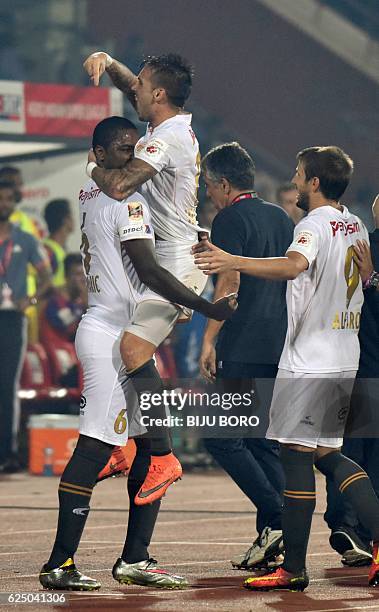 Northeast United FC's midfielder Kaffi Ndri celebrates with his teammates after scoring a goal during the Indian Super League football match between...