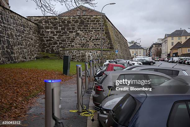 Electric vehicles sit parked at charging stations at Kongens gate near Akershus festning in Oslo, Norway, on Monday, Nov. 21, 2016. The International...