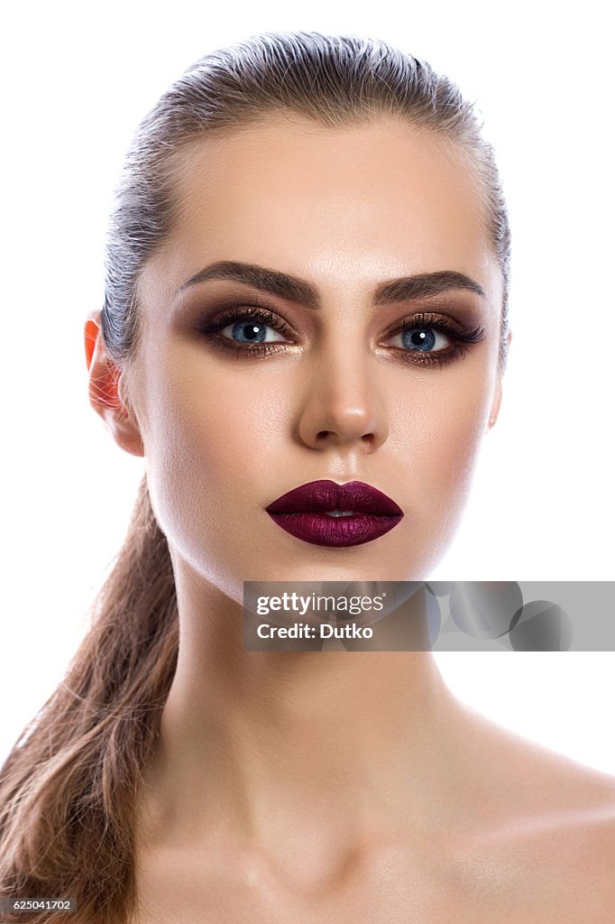 Portrait of young woman with modern makeup