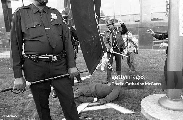 Protesters prepare to hang an effigy of Ronald Regan at a protest organized by AIDS activist group ACT UP at the headquarters of the Food and Drug...