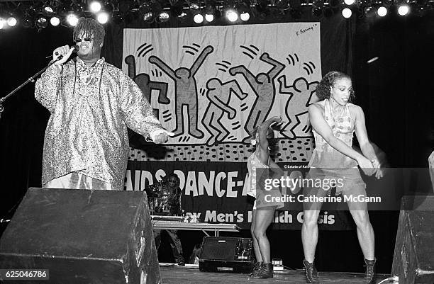 Prince Be of PM Dawn performs before a Keith Haring banner at AIDS Dance-a-Thon on November 30th, 1991 at Rosalind Ballroom in New York City, New...