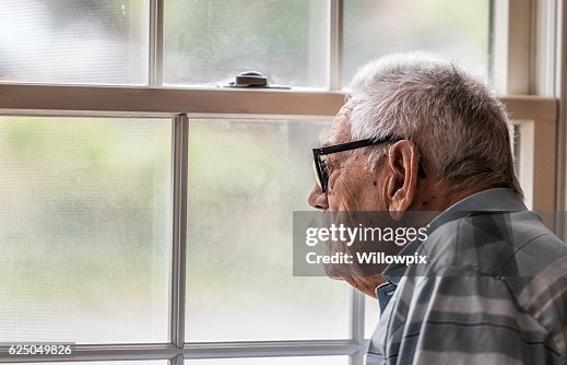 Wistful Senior Man Staring Through Hazy Window Wistful Senior Man Staring Through Hazy Window