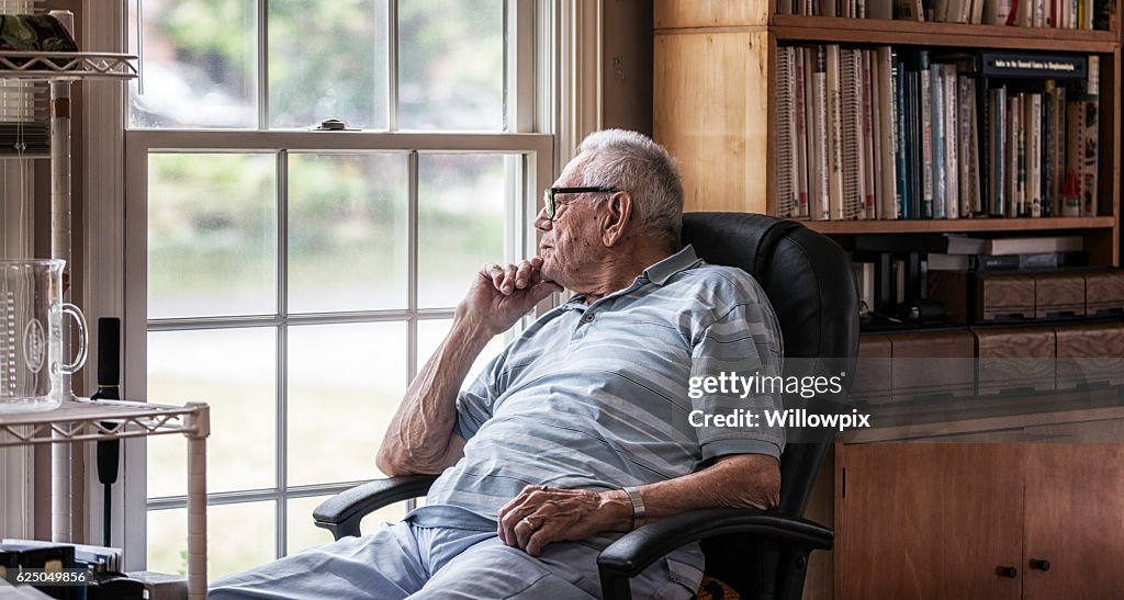Day Dreaming Elderly Senior Man Staring Through Hazy Window