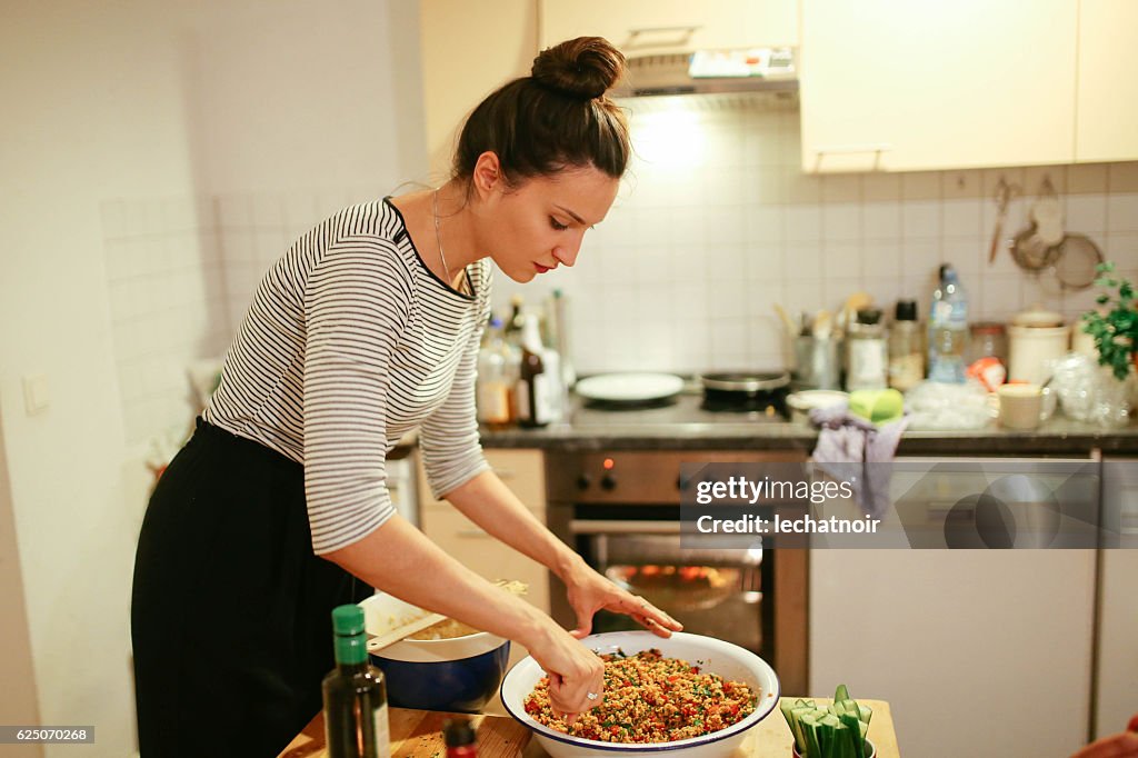 Young woman preparing food on the table