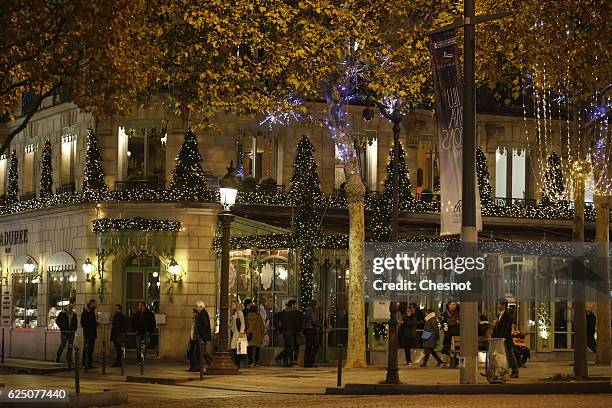 The facade of the restaurant "Laduree" is illumined for Christmas and New Year celebrations on the Champs-Elysee avenue on November 22, 2016 in...