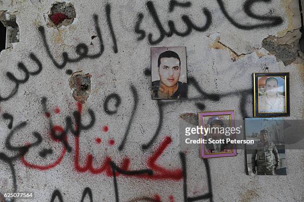 Portraits of victims mark the memorial to the Islamic State massacre of 1,700 Shiite Air Force cadets from Camp Speicher beneath a bridge where...