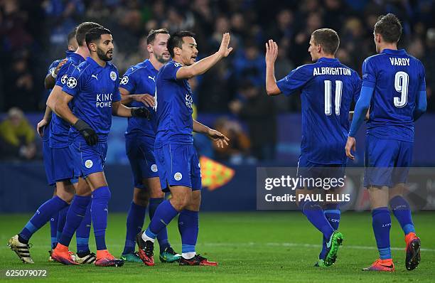 Leicester City's Algerian midfielder Riyad Mahrez celebrates scoring his team's second goal from the penalty spot with Leicester City's Japanese...