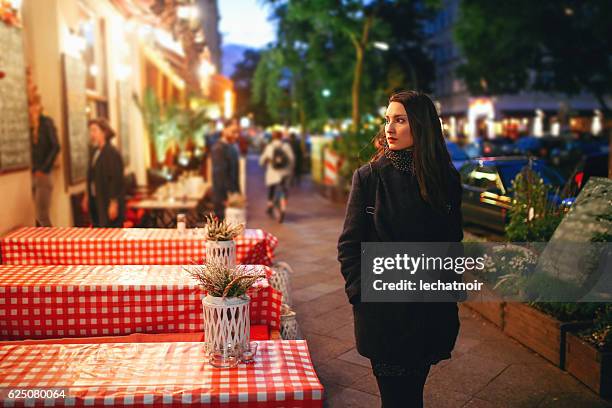 young woman walking on the streets of berlin at night - kreuzberg stock pictures, royalty-free photos & images