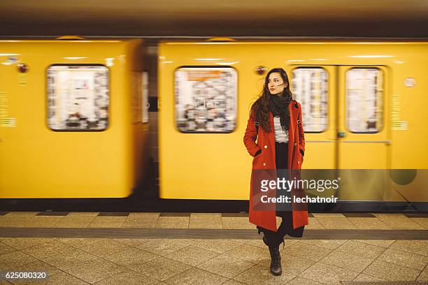 young woman in berlin subway station - berlin stock pictures, royalty-free photos & images