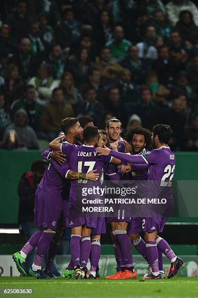 Real Madrid's players celebrate after Real Madrid's French defender Raphael Varane scored during the UEFA Champions League football match Sporting CP...