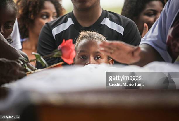 Mourners gather over the casket of Leonardo Martins da Silva Junior who was killed during a weekend police operation in the Cidade de Deus 'City of...