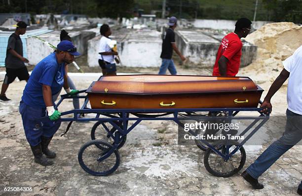 Father and pastor Leonardo Martins da Silva helps move the casket during the burial of his son Leonardo Martins da Silva Junior who was killed during...