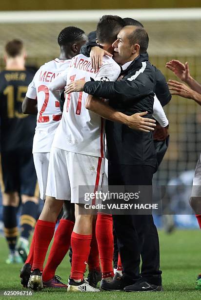 Monaco's Portuguese coach Leonardo Jardim celebrates with Monaco's Argentinian forward Guido Carrillo after winning the UEFA Champions League group E...