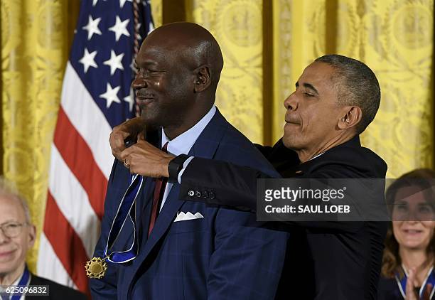 President Barack Obama presents NBA star and athlete Michael Jordan with the Presidential Medal of Freedom, the nation's highest civilian honor,...