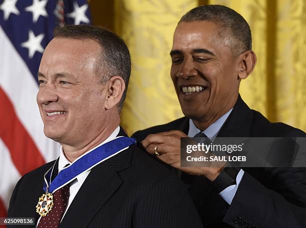 President Barack Obama presents actor Tom Hanks with the Presidential Medal of Freedom, the nation's highest civilian honor, during a ceremony...