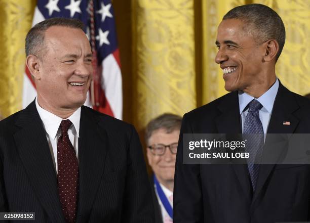 President Barack Obama smiles before presenting actor Tom Hanks with the Presidential Medal of Freedom, the nation's highest civilian honor, during a...