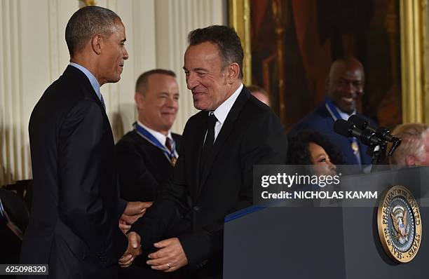 President Barack Obama presents Singer Bruce Springsteen with the Presidential Medal of Freedom, the nation's highest civilian honor, during a...