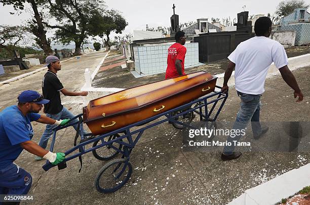 Father and pastor Leonardo Martins da Silva helps move the casket during the burial of his son Leonardo Martins da Silva Junior who was killed during...