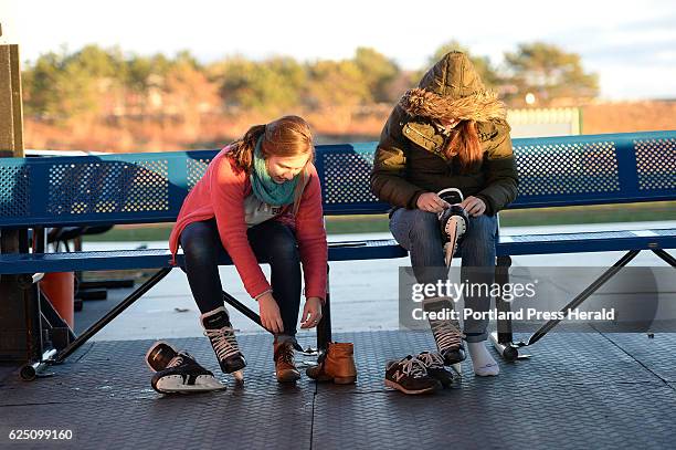 Allison Giannotti of Durham, N.H. And Miranda Foster of New York City lace up their skates at The Rink at Thompson's Point Saturday, November 19,...