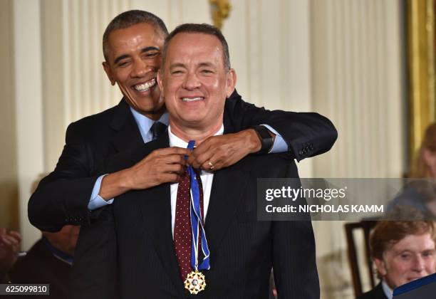 President Barack Obama presents actor Tom Hanks with the Presidential Medal of Freedom, the nation's highest civilian honor, during a ceremony...