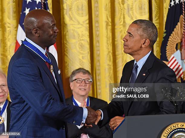 President Barack Obama and NBA athlete Michael Jordan shake hands during the presentation of the Presidential Medal of Freedom, the nation's highest...