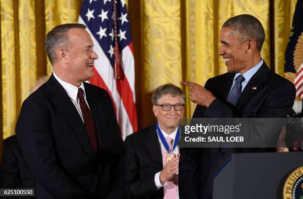 President Barack Obama smiles before presenting actor Tom Hanks with the Presidential Medal of Freedom, the nation's highest civilian honor, during a...