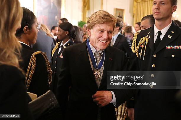 Motion picture legend Robert Redford leaves an East Room ceremony where he was awarded the Presidential Medal of Freedom at the White House November...