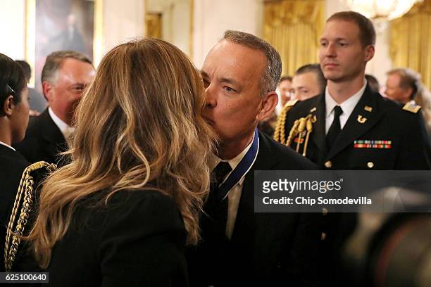 Actor, filmmaker and social justice advocate Tom Hanks kisses his wife Rita Wilson after he was awarded the Presidential Medal of Freedom during a...