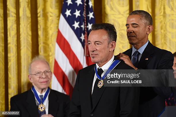 President Barack Obama presents Singer Bruce Springsteen with the Presidential Medal of Freedom, the nation's highest civilian honor, during a...