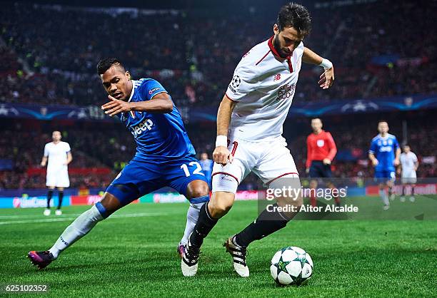 Nicolas Pareja of Sevilla FC being followed by Alex Sandro of Juventus during the UEFA Champions League match between Sevilla FC and Juventus at...