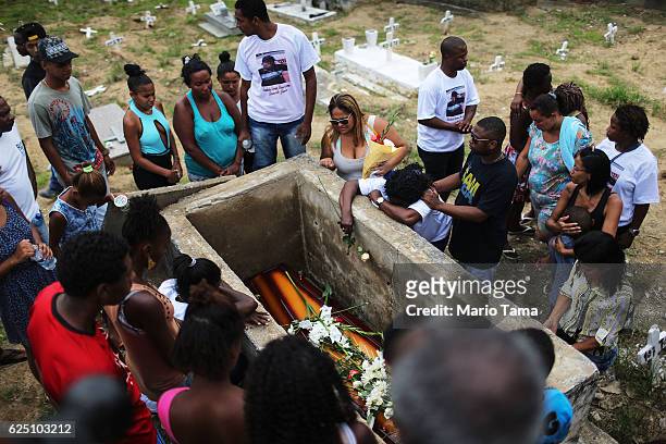Mourners gather around the casket during the burial of Leonardo Martins da Silva Junior who was killed during a weekend police operation in the...