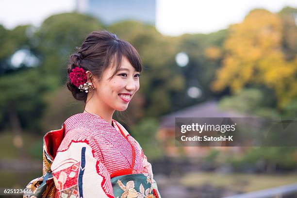 young furisode girl smiling in garden - seijin no hi stock pictures, royalty-free photos & images