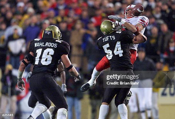 Inside linebacker Sean Tufts of the Colorado Buffaloes hits John Gibson of the Nebraska Cornhuskers who knocks the ball into the hands of linebacker...