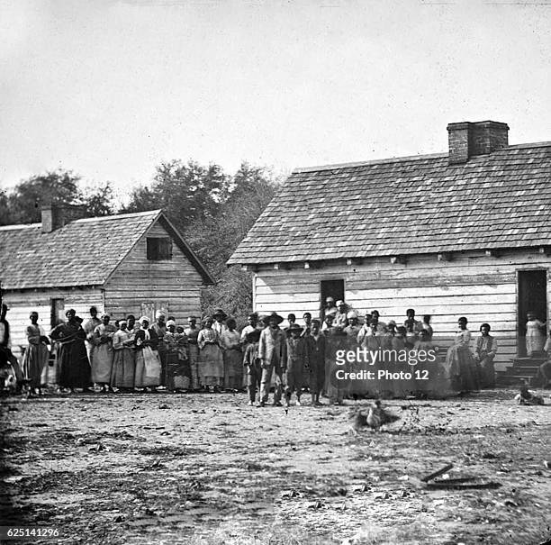 Plantation slaves gathered outdside their huts, Virginia.