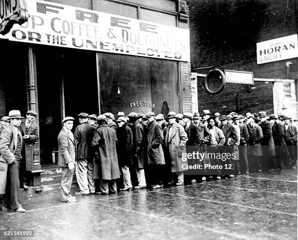 View of unemployed men as they line up outside a soup kitchen organized by mobster Al Capone, Chicago, Illinois, late 1930 or early 1931. .