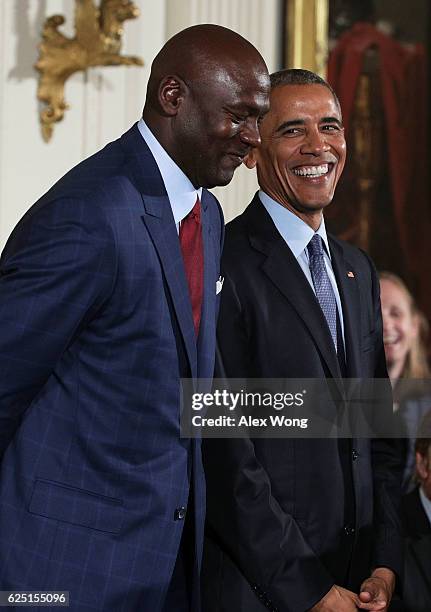 President Barack Obama stands with former NBA player Michael Jordan during the Presidential Medal of Freedom presentation ceremony at the East Room...