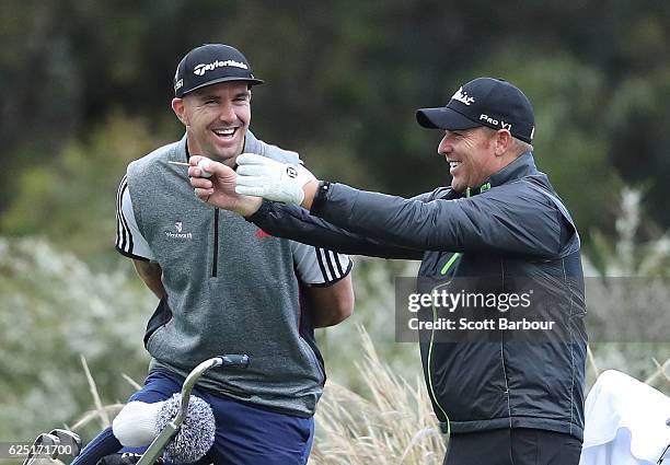 Former cricketers Kevin Pietersen and Shane Warne look on as they play with Graeme McDowell of Northern Ireland on Pro-Am Day ahead of the World Cup...