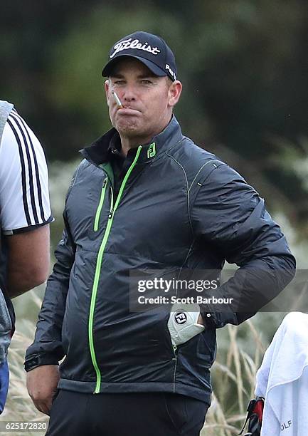 Former cricketer Shane Warne looks on as he plays with Graeme McDowell of Northern Ireland on Pro-Am Day ahead of the World Cup of Golf at Kingston...