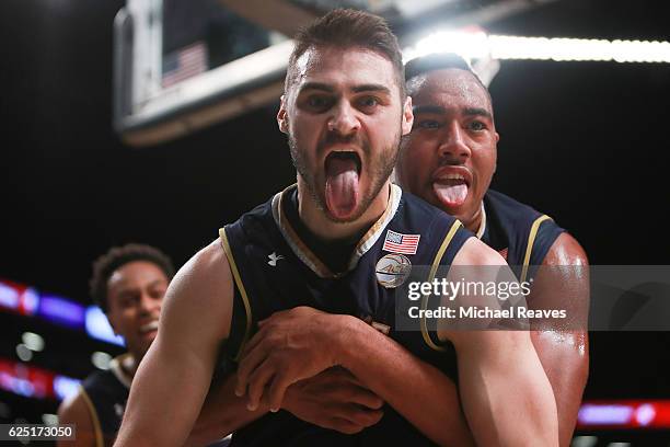 Matt Farrell of the Notre Dame Fighting Irish celebrates with Bonzie Colson after scoring the go-ahead basket with 14.7 seconds left as they defeated...