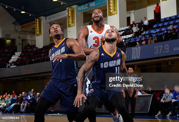 Wayne Selden and Quinton Chievous of the Iowa Energy play defense against Keith Wright of the Westchester Knicks at the Westchester County Center on...