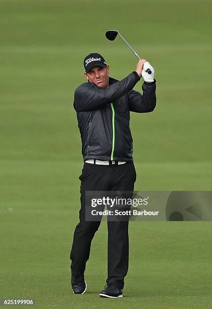 Former cricketer Shane Warne plays a shot on Pro-Am Day ahead of the World Cup of Golf at Kingston Heath Golf Club on November 23, 2016 in Melbourne,...