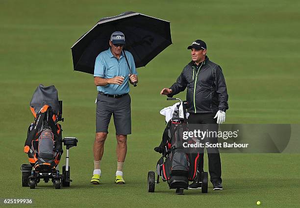 Former cricketer Shane Warne and former AFL player Sam Newman look on on Pro-Am Day ahead of the World Cup of Golf at Kingston Heath Golf Club on...